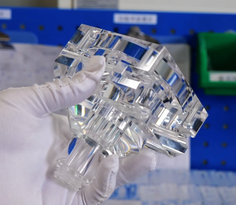 CNC machined clear acrylic PMMA block with machined holes and precision edges for prototyping