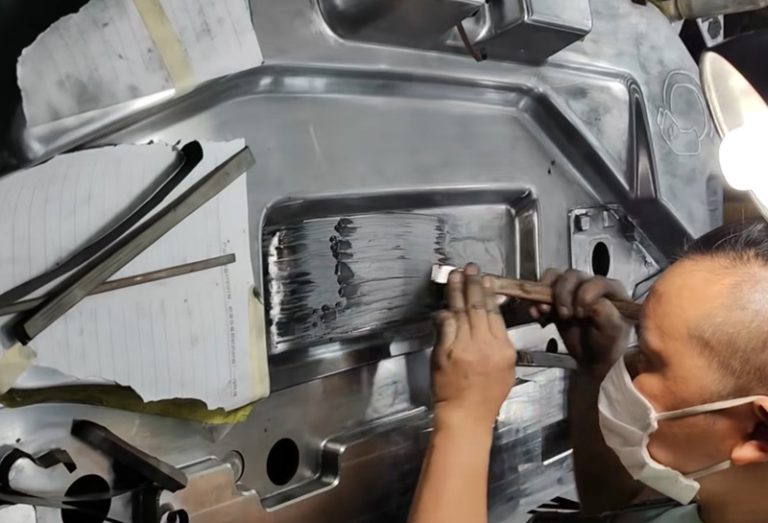 Technician hand-polishing mold cavity to mirror finish